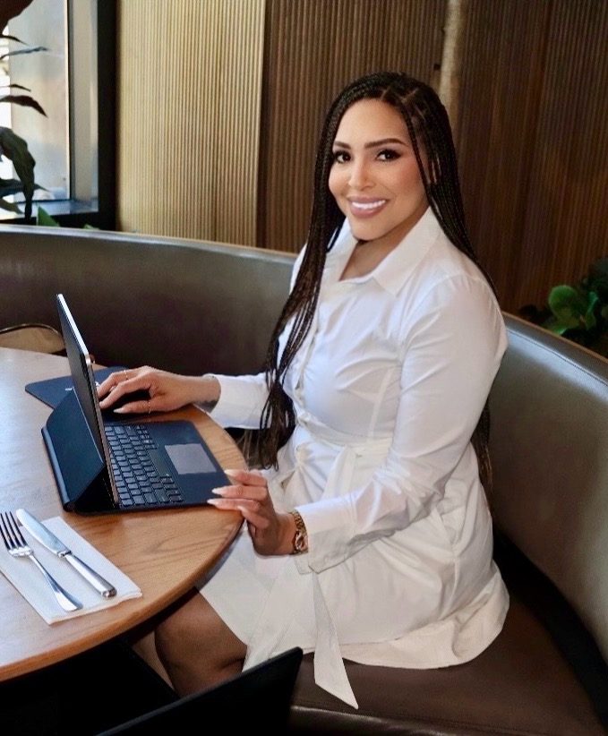 ANichole Consulting founder working at a laptop
